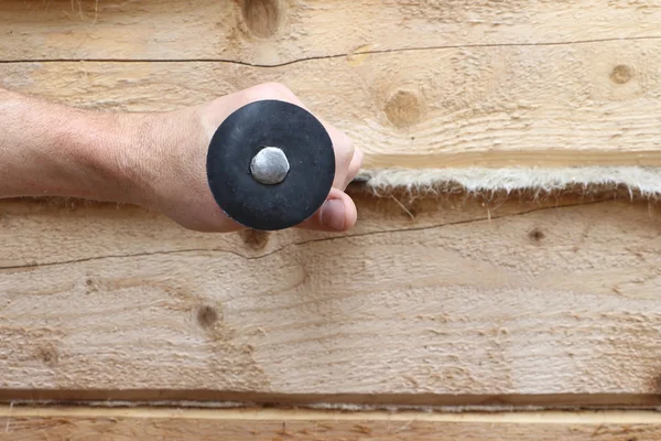 The male hand with a chisel pushes a heater in a wall from a bar — Stock Photo, Image