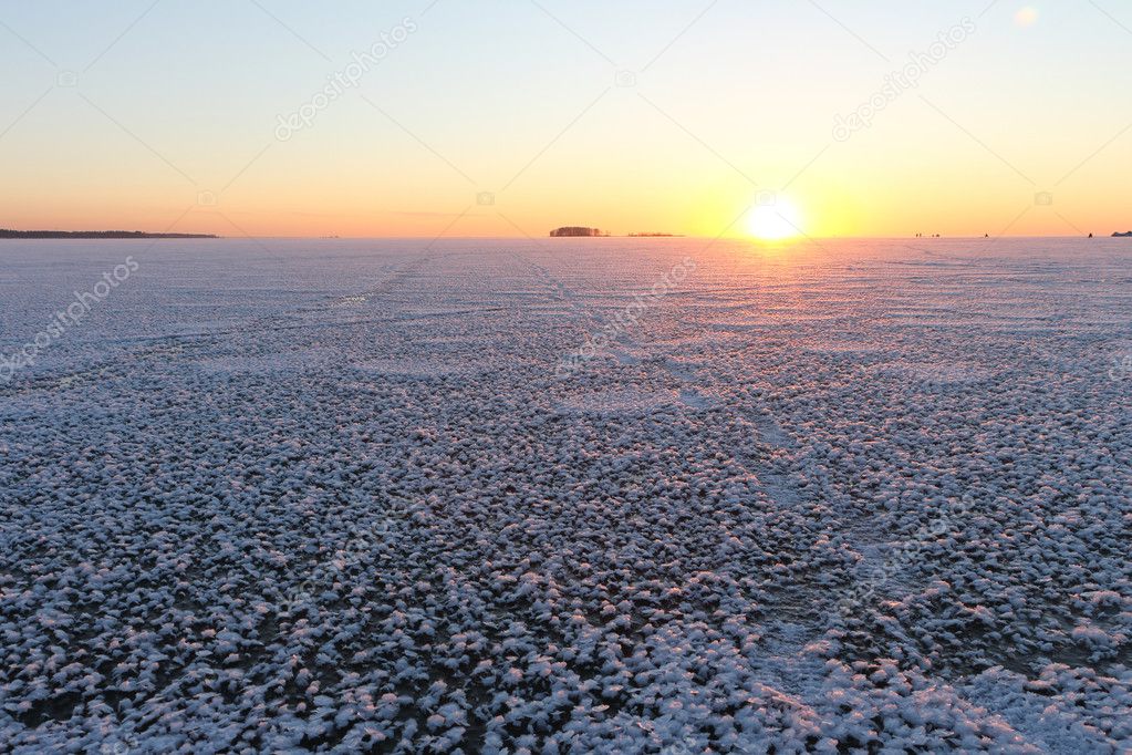 Sunset on the frozen river in the fall, River Ob, Siberia, Russi