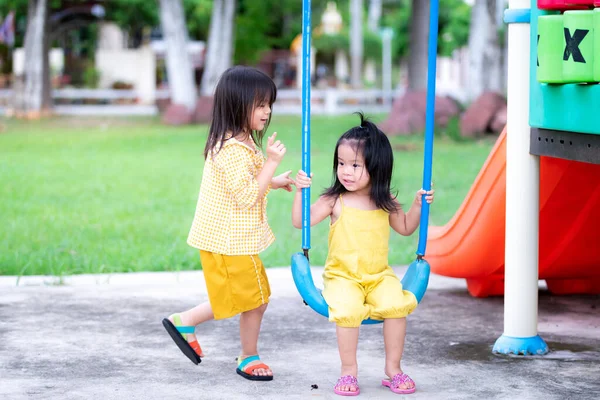 Two Girls Share Swing Eldest Teaching Youngest Sister Swing Blue — Stock Photo, Image