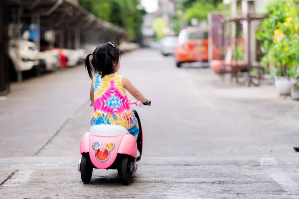 Sisi Belakang Anak Perempuan Mengendarai Sepeda Motor Listrik Untuk Mainan — Stok Foto