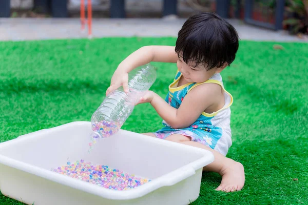 Preschool Baby Boy Using Two Hands Hold Clear Bottle Pour — Stock Photo, Image