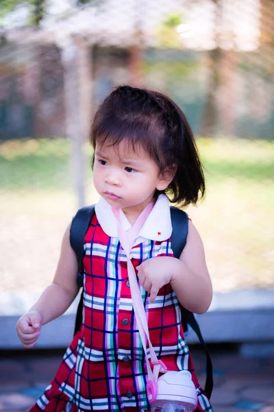 Foto Stock Cute 2 year old Asian toddler girl concentrates lifting