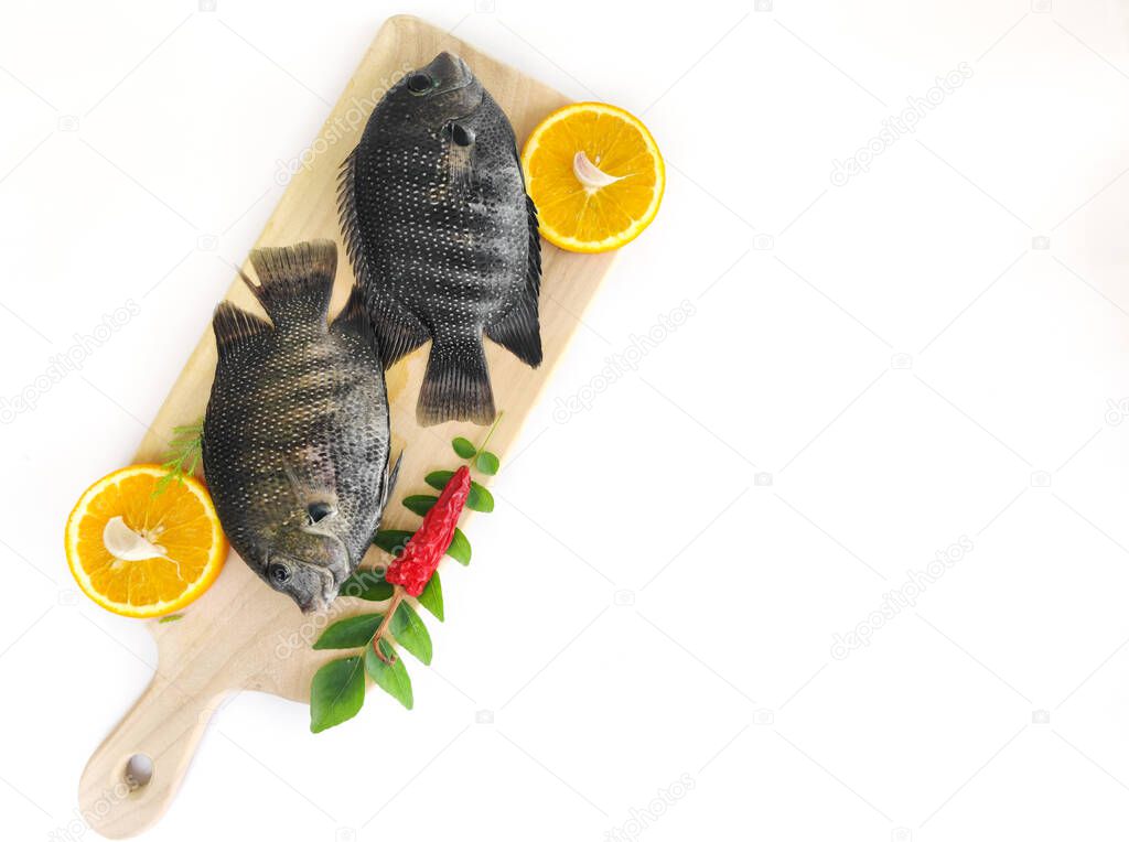 pearl spot fish /Karimeen decorated with herbs and fruits. isolated on white Background.Space for text,Selective focus.