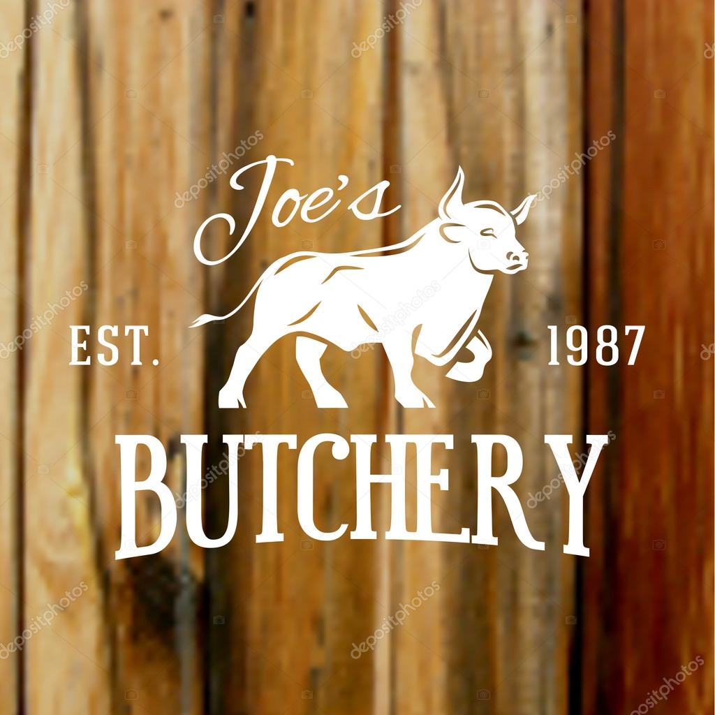 Premium vintage beef bull label on blurred wood background. Vector butchery logo design