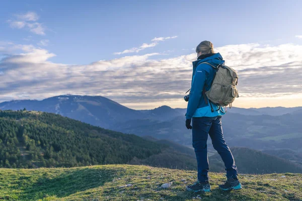 Gün batımında dağın tepesinde. Concetto di Sucso. Donna in piedi in cime ad una montagna.