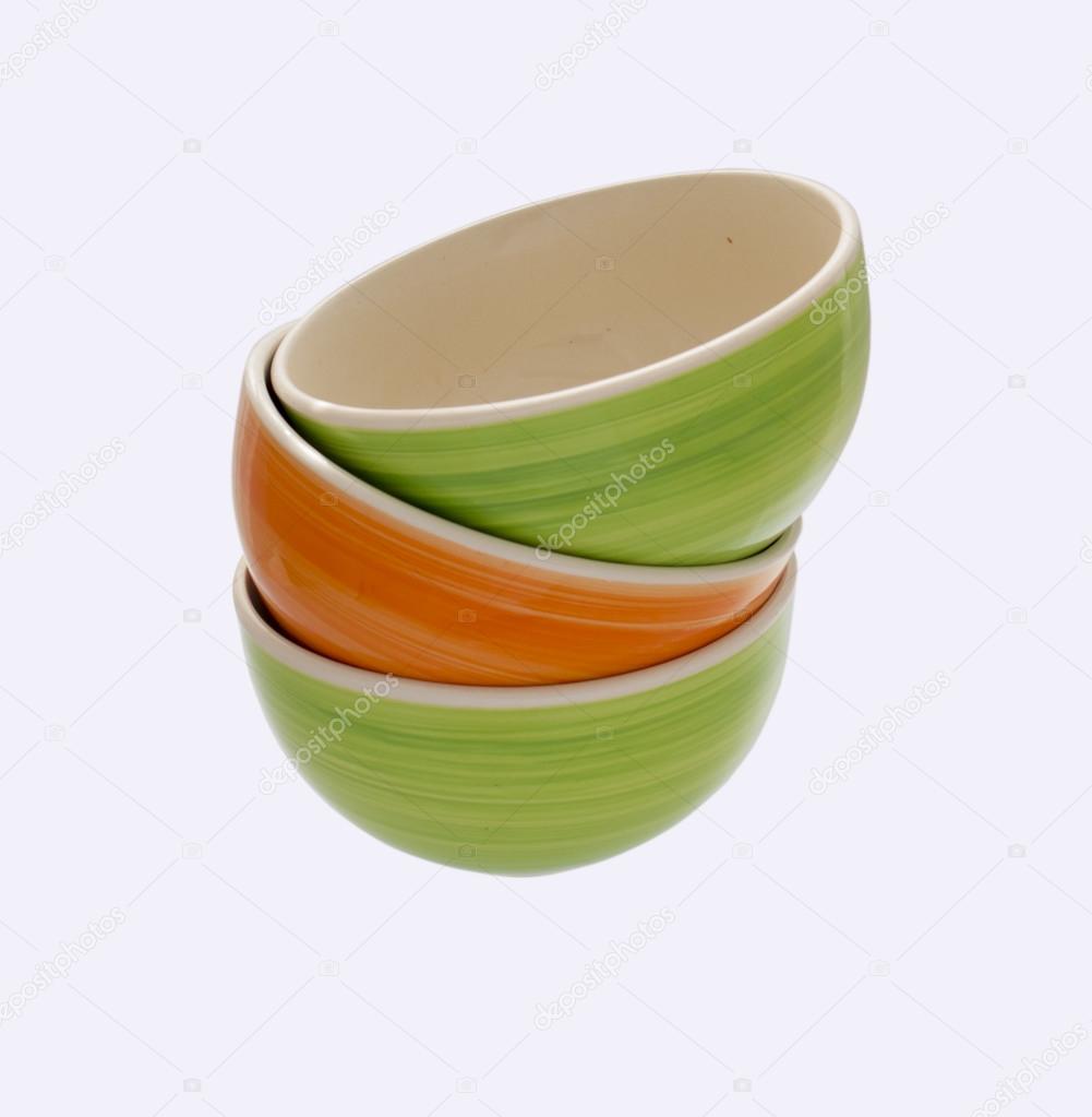 a tower of green and orange ceramic plates, natural bright color