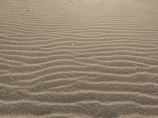 Sand natürlicher Hintergrund mit welligen Linien — Stockfoto