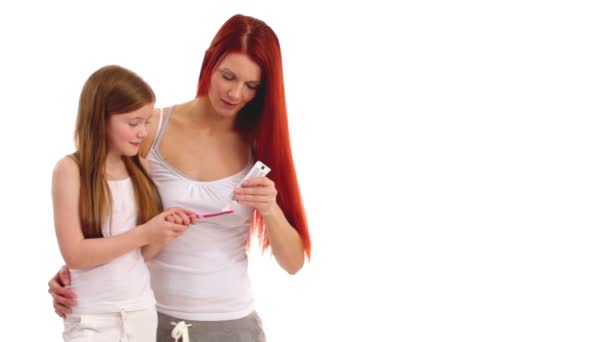 Mother and daughter brushing their teeth — Stock Video