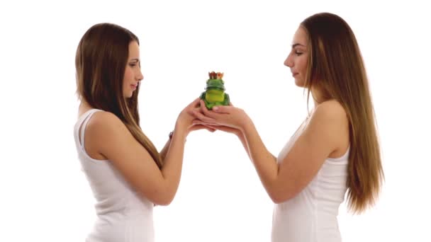 Young girls kissing toy frog — Stock Video