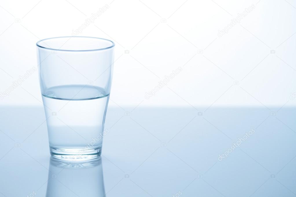 Glass with water on table Stock Photo by ©Canopus 76476611
