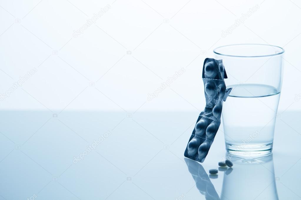 Glass of water with tablets