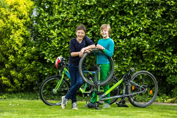 Twee jongens een fiets repareren Rechtenvrije Stockafbeeldingen