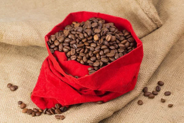 Coffe beans in red velvet sac — Stock Photo, Image