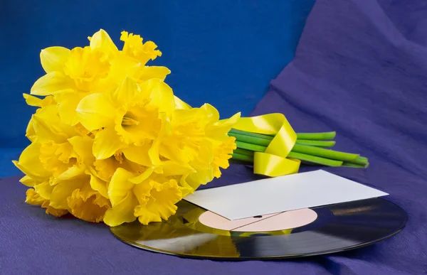 Flores de narciso, envelope no fundo com registro de vinil — Fotografia de Stock
