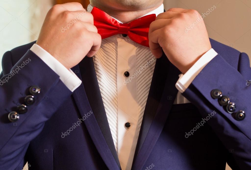 traje con pajarita roja | novio en una camisa blanca y traje azul