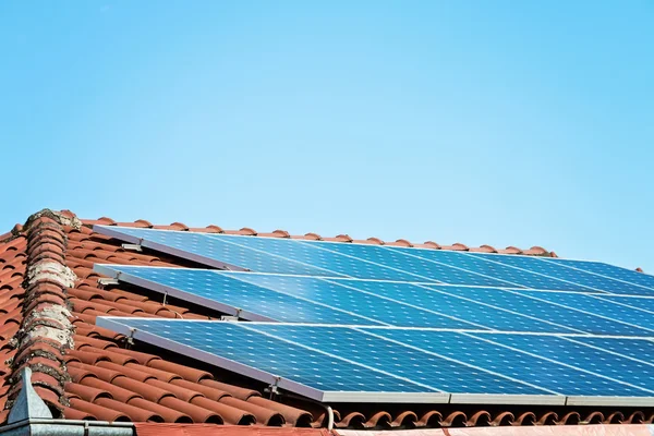 Kırmızı çatıdaki güneş paneli