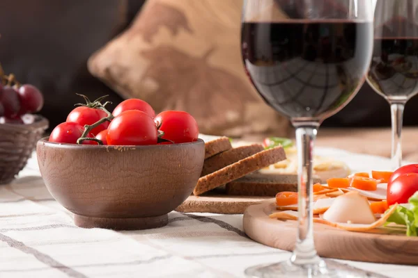 Homemade dinner with bread, tomatoes, cheese, ham and wine — Stock Photo, Image