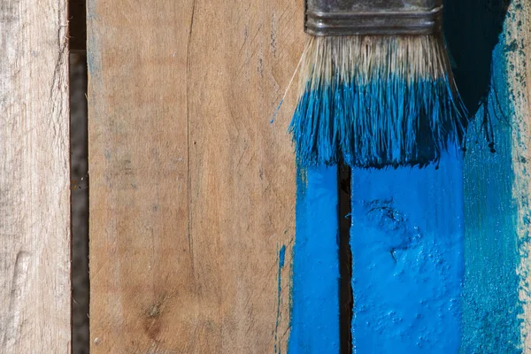 Closeup Of Pine Plank Being Painted In Blue Color Stock Image