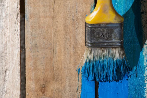 Closeup Of Pine Plank Being Painted In Blue Color Royalty Free Stock Photos