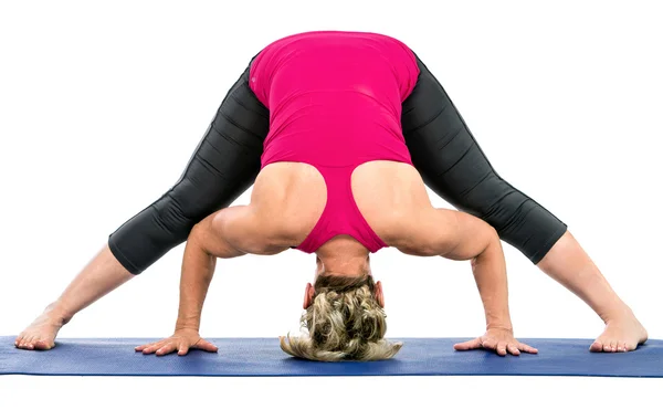 Middle age woman doing yoga exercises Royalty Free Stock Photos