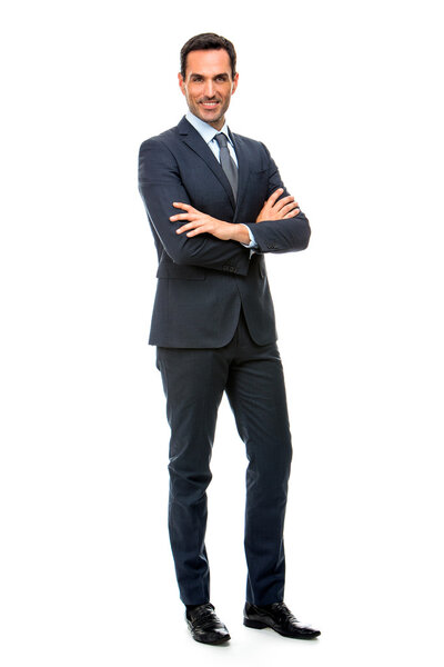 Full length portrait of a smiling businessman looking at camera with crossed arms