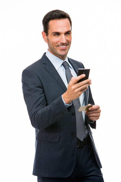 Half length portrait of a smiling businessman holding mobile phone and credit card