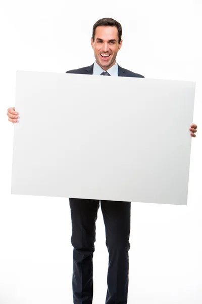 Retrato de comprimento total de um empresário sorridente segurando um cartaz branco — Fotografia de Stock