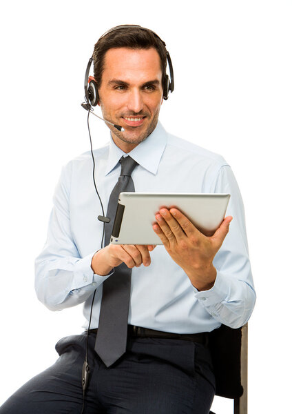 Portrait of a smiling businessman with headset and digital tablet