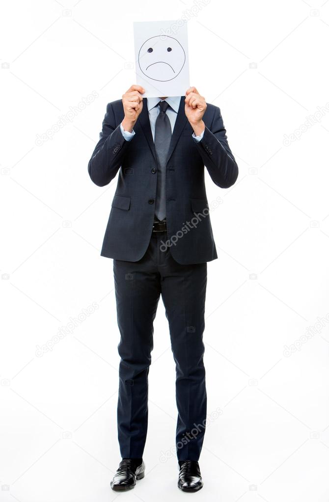 Full length portraif of a businessman holding white card with emoticon on it