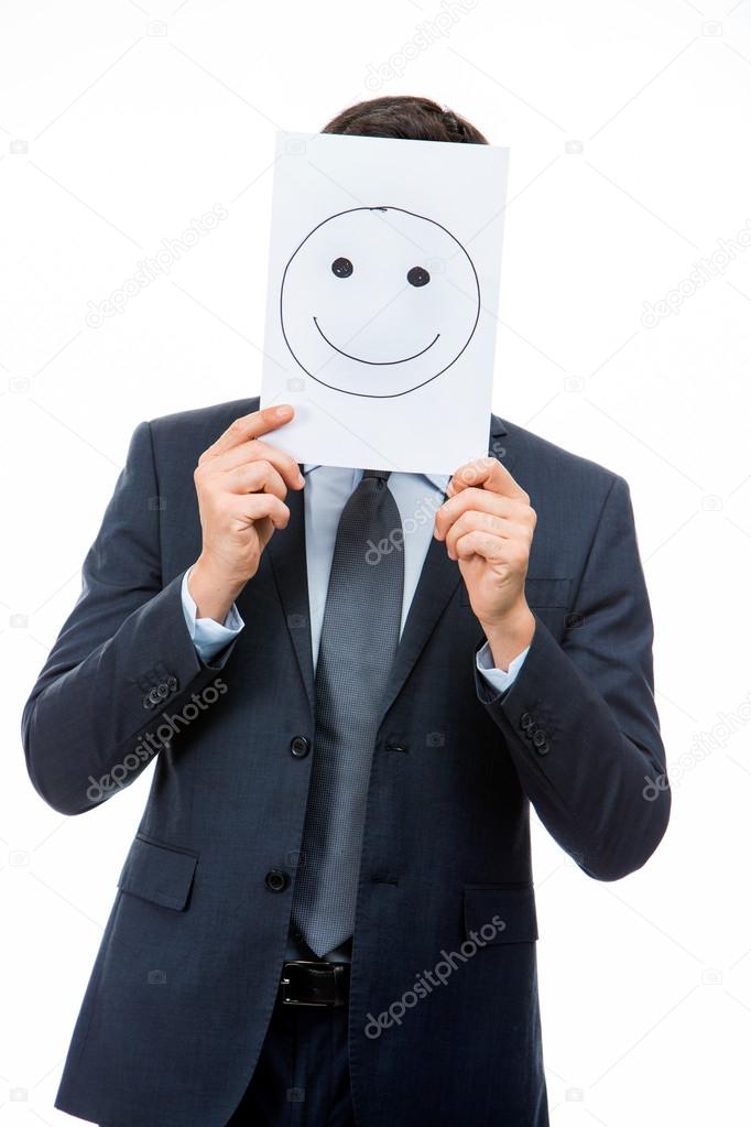 Half length portraif of a businessman holding white card with emoticon on it