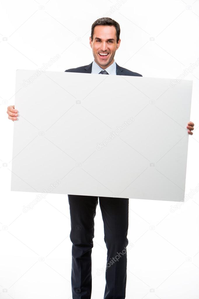 Full length portrait of a smiling businessman holding a white placard