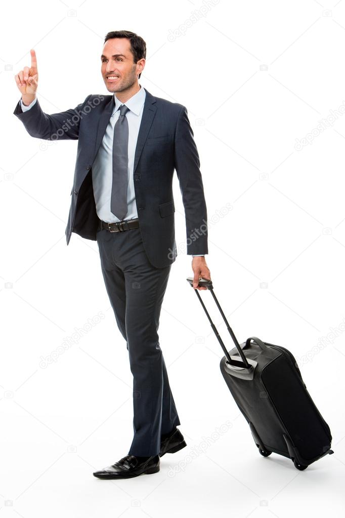 Full length portrait of a businessman with trolley stopping a taxi