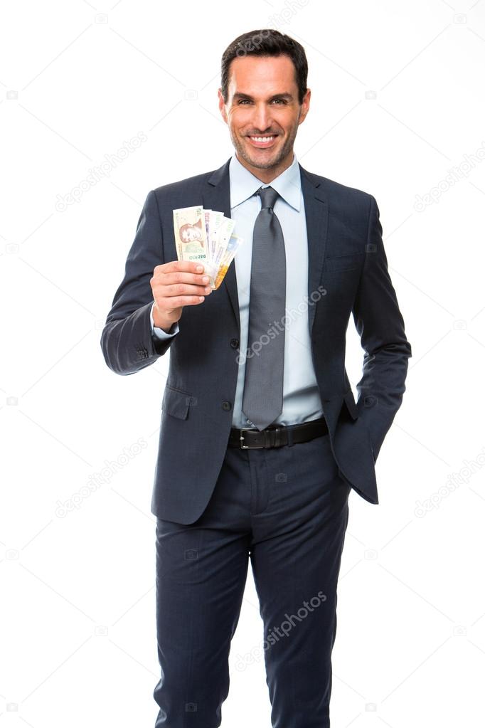 Half lenth portrait of a businessman smiling and holding money