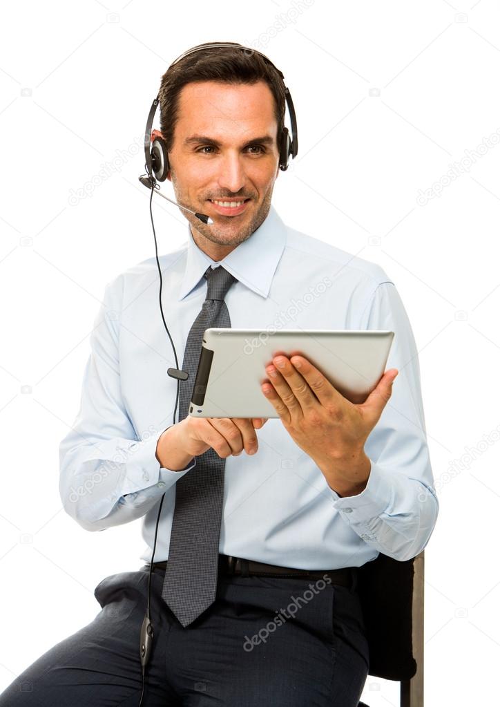 Portrait of a smiling businessman with headset and digital tablet