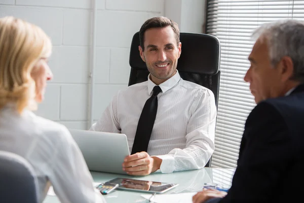 Three businesspeople having a meeting in the office with a laptop computer and a digital tablet — Stock Photo, Image