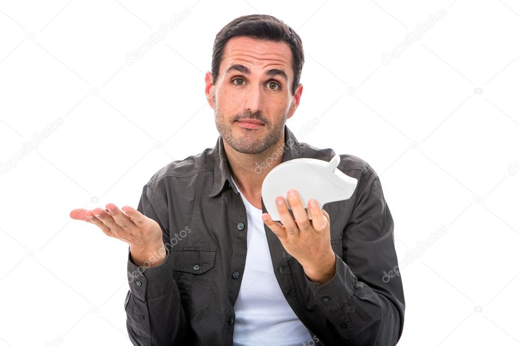 Portrait of a man looking at camera and showing a piggybank