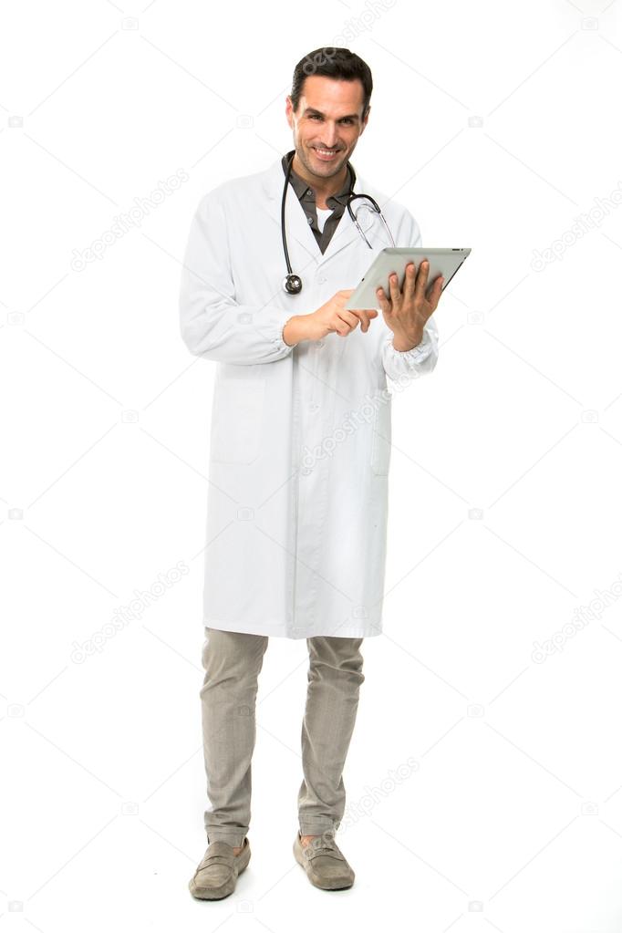 Full length portrait os a smiling male doctor with stethoscope while working with a digital tablet