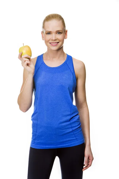 Kvinna i fitness kläder med äpple — Stockfoto