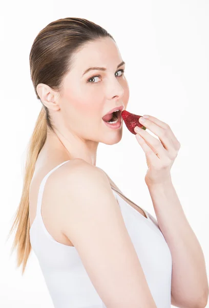 Woman eating strawberry — Stock Photo, Image