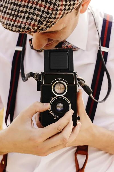 Stylish hipster man holding camera — Stock Photo, Image