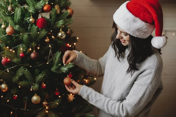 Happy Young Woman Santa Hat Decorating Modern Christmas Tree Golden — Stock Photo, Image