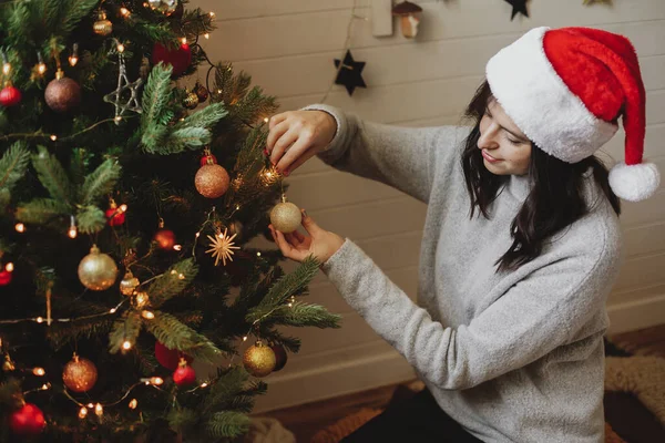 Happy Young Woman Santa Hat Decorating Modern Christmas Tree Golden — Stock Photo, Image