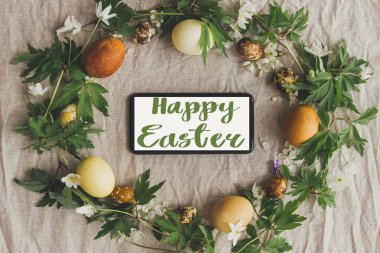 Paskalya tatilin kutlu olsun. Paskalya kırsalında yumurta ve çiçeklerle süslenmiş el yazısıyla yazılmış mutlu paskalya metinleri. Güzel, şık bir tebrik kartı. Mevsimler selamlar