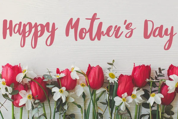 幸せな母親の日 幸せな母の日のテキストと赤いチューリップ 白木のフラットレイアウト上のデイジーの花の境界線 スタイリッシュな花のグリーティングカード 手書き文字 母の日 — ストック写真