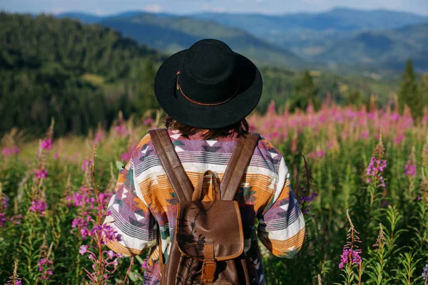 Kvinna Resenär Med Ryggsäck Och Hatt Står Vackra Vilda Blommor — Stockfoto