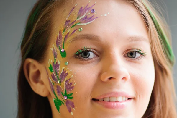 Girl with flower bodyart and sunflowers bouquet