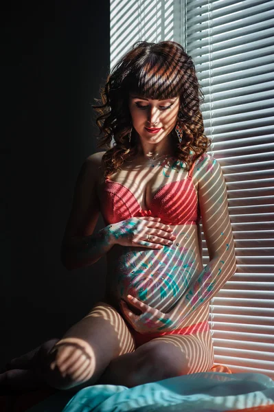 Young pregnant woman with bodyart on her belly — Stock Photo, Image