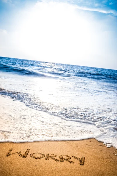 Worry written into the sand on a beach — Stock Photo, Image