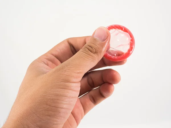 Main avec préservatif sur fond blanc — Photo