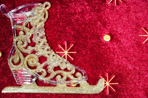 Background, abstraction. Ice skates for figure skating on a red background with snowflakes.